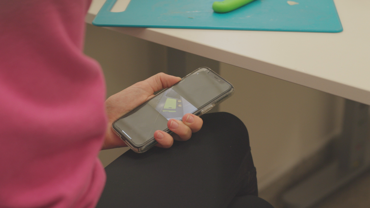 Learner using AutonoMe app for cooking skills.